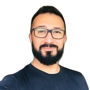 Syed Zaidi, smiling, in glasses and a dark T-shirt